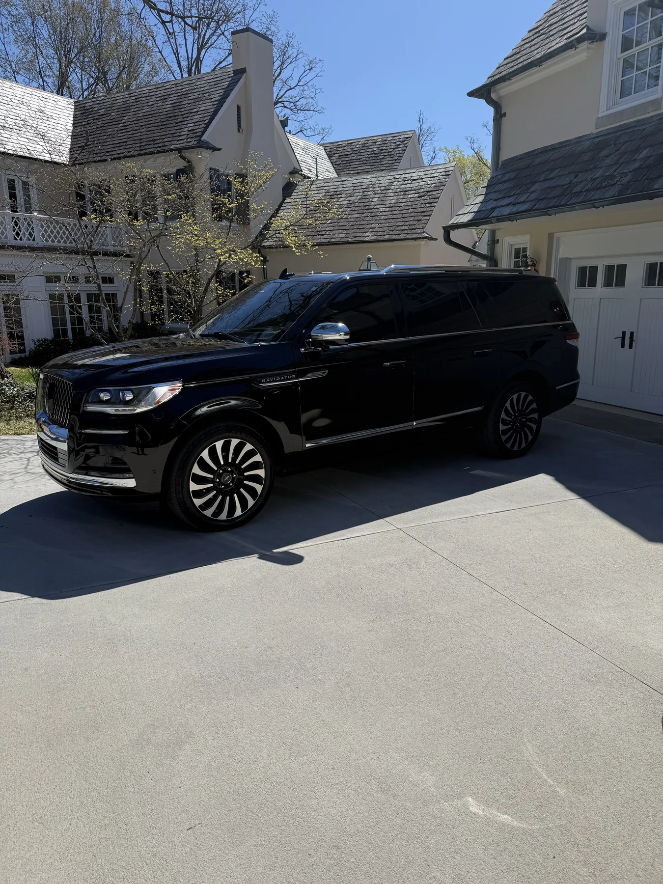 Black Lincoln Navigator Black Label outside a residence