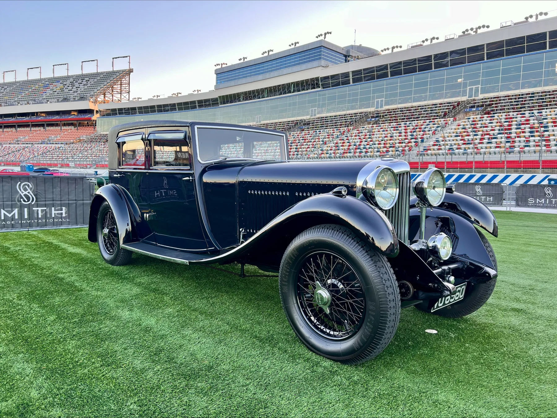 Vintage motorcar displayed on a stadium field